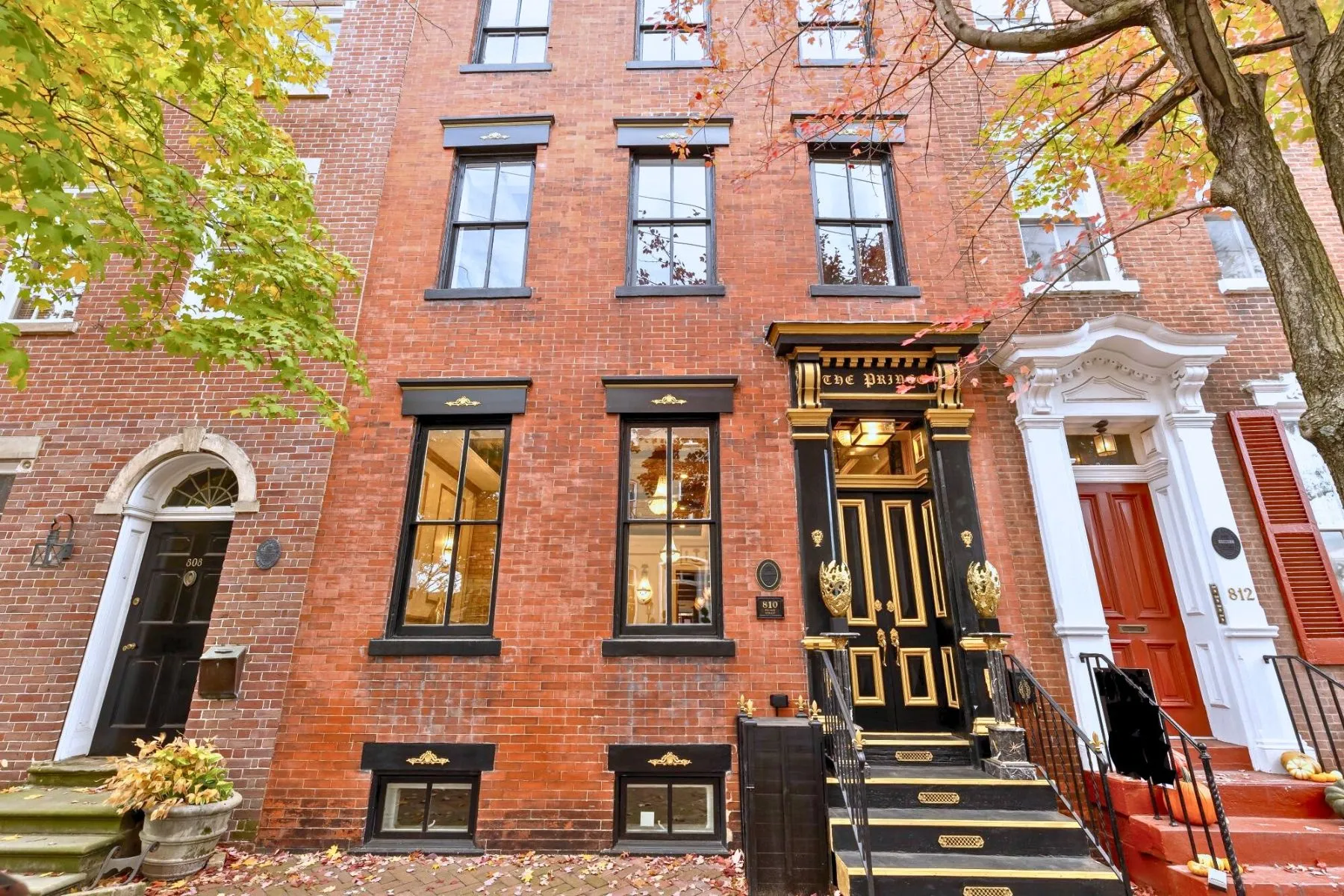 810 Prince Street Alexandria VA Bricj townhouse facade of 810 Prine Street with Black door and gold accents