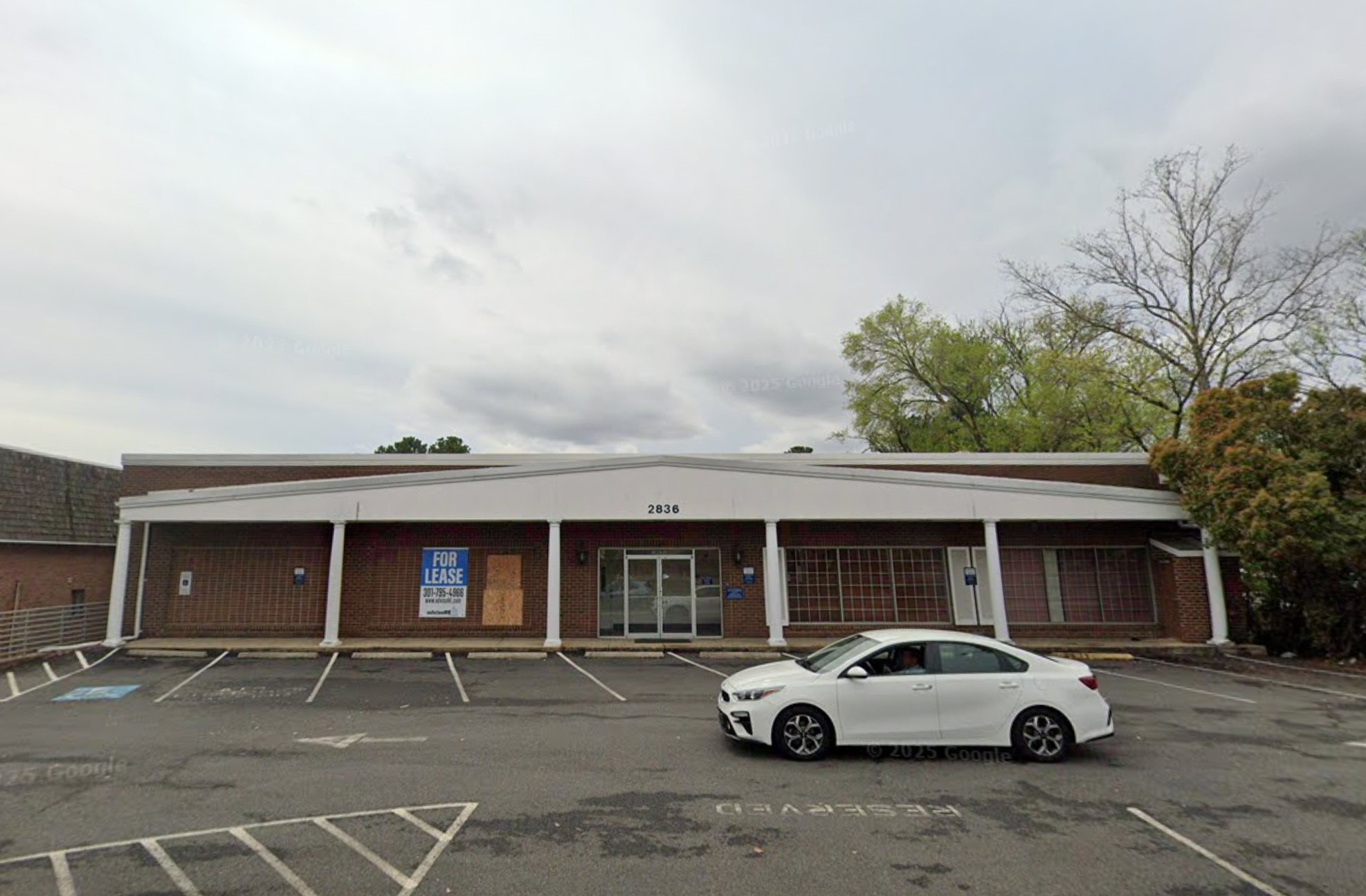 Red brick Building with big parking lot