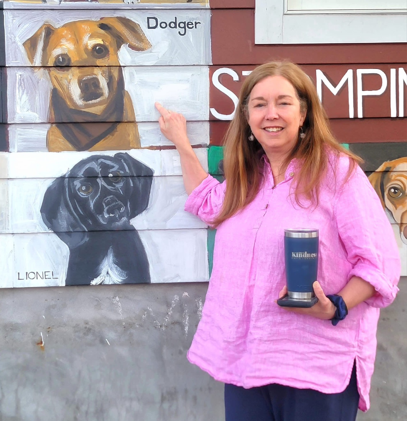 Gayle Reuter points out a painting of her late dog, Dodger, who was immortalized on the Wall of Dogs that faces Pat Miller Square in Del Ray Gayle Reuter points out a painting of her late dog, Dodger, who was immortalized on the Wall of Dogs that faces Pat Miller Square in Del Ray.