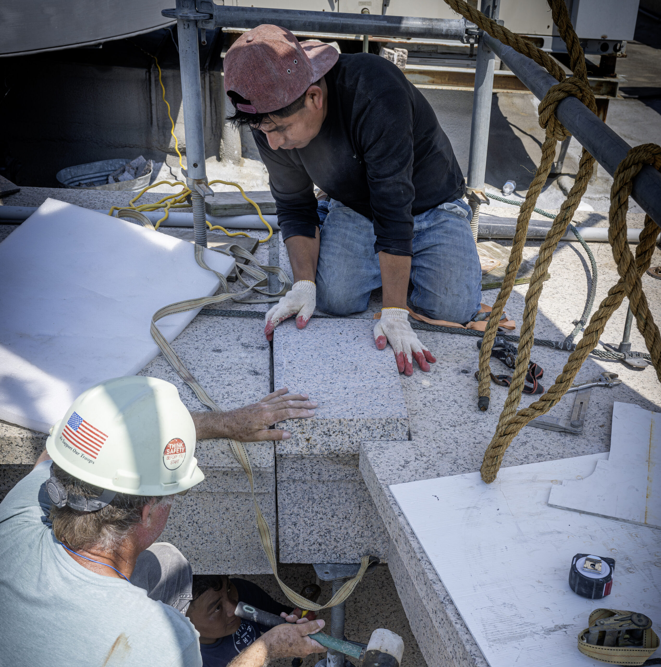 2025 ZEBRA last stone In the last major repair to the Memorial’s exterior, workers lower a fresh-carved replacement stone into place. The original coping in that corner shattered during the 2011 earthquake.
