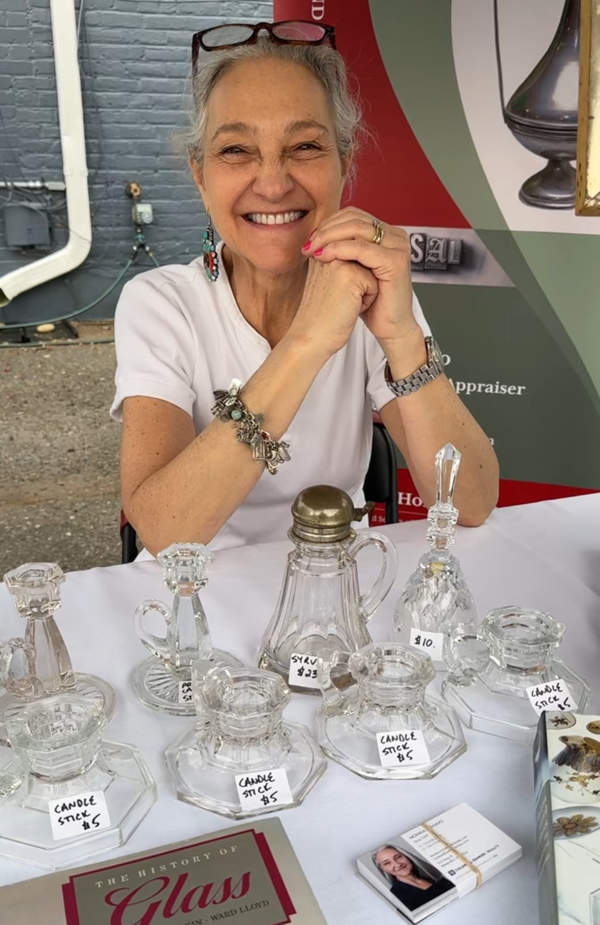 Monika Schiavo from Coldwell Banker Realty at the Del Ray Vintage & Flea Market. Schiavo, who does free antique appraisals for the monthly Vintage & Flea market, is sponsoring this month’s First Thursday. PHOTO BY AMY EGGERS