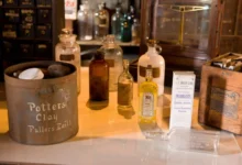 Apothecary Bottles with different labels and fluid levels on a counter.