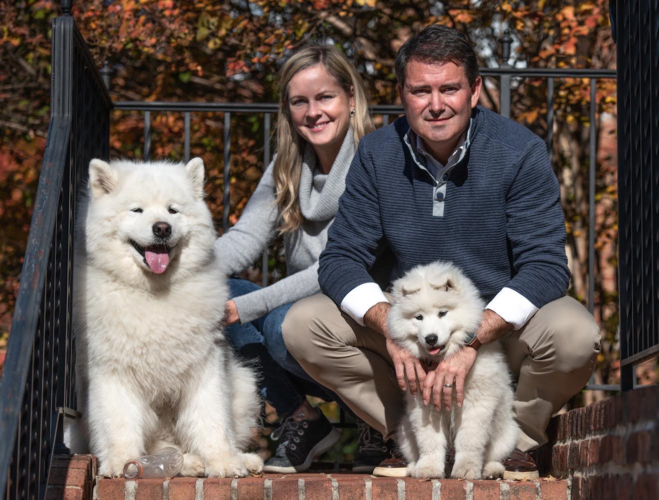 Mason Butler and his wife Kristin with two white dogs