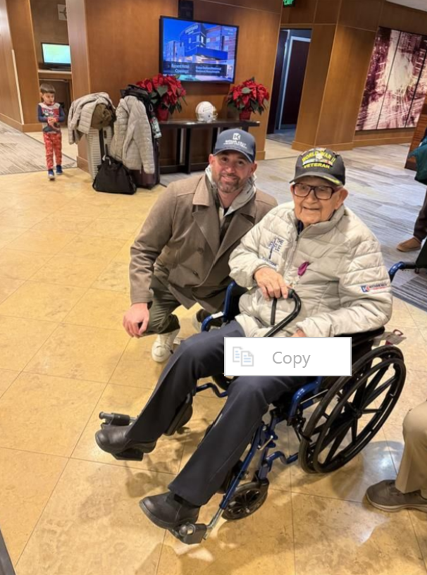 Michael Kelly Injury Lawyers supported Back to the Battlefield, returning World War II veterans to Belgium to honor their service, sacrifice, and enduring legacy. World War II Battle of the Bulge Veteran in a wheelchair with another man beside him.