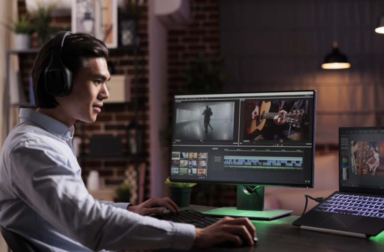 male freelancer working movie production with computer software editing film montage with audio visual effects