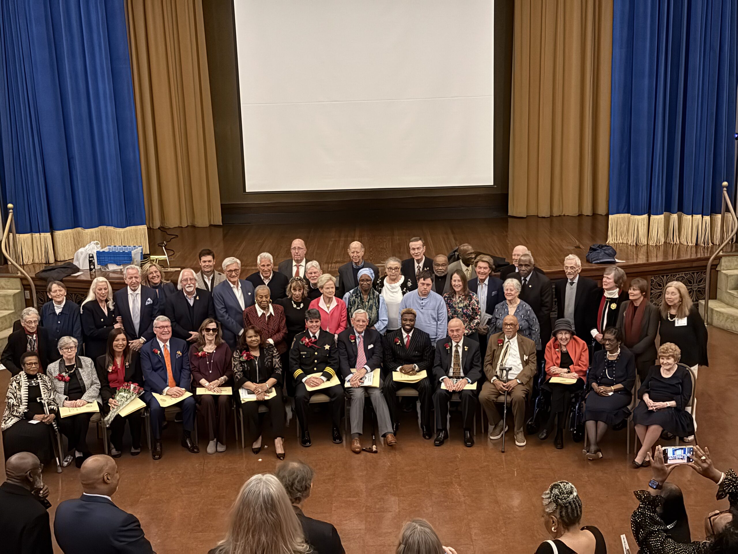 Living Legends of Alexandria Group Group photo of Living Legends of Alexandria honorees and board members gathered on stage during the 2025 Living Legends induction reception in Alexandria, Virginia.