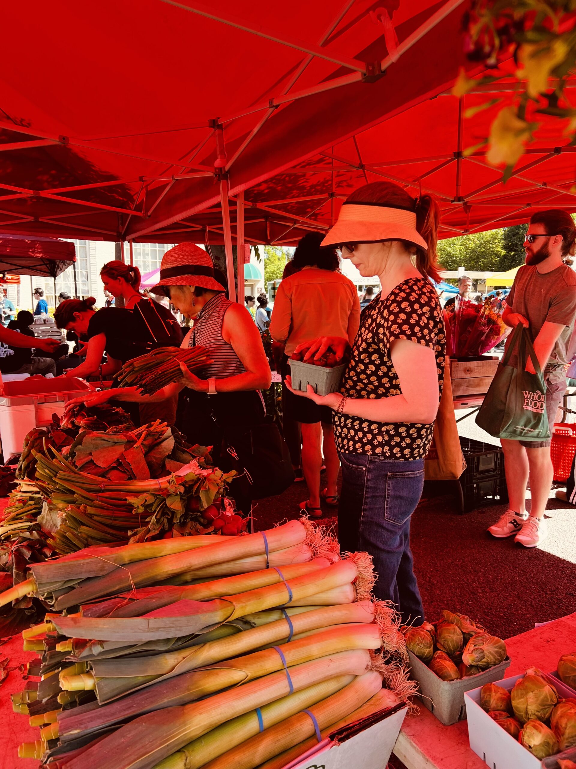 Visitors at the market delight in the diverse selection of seasonal vegetables, taking in the various aromas and textures.