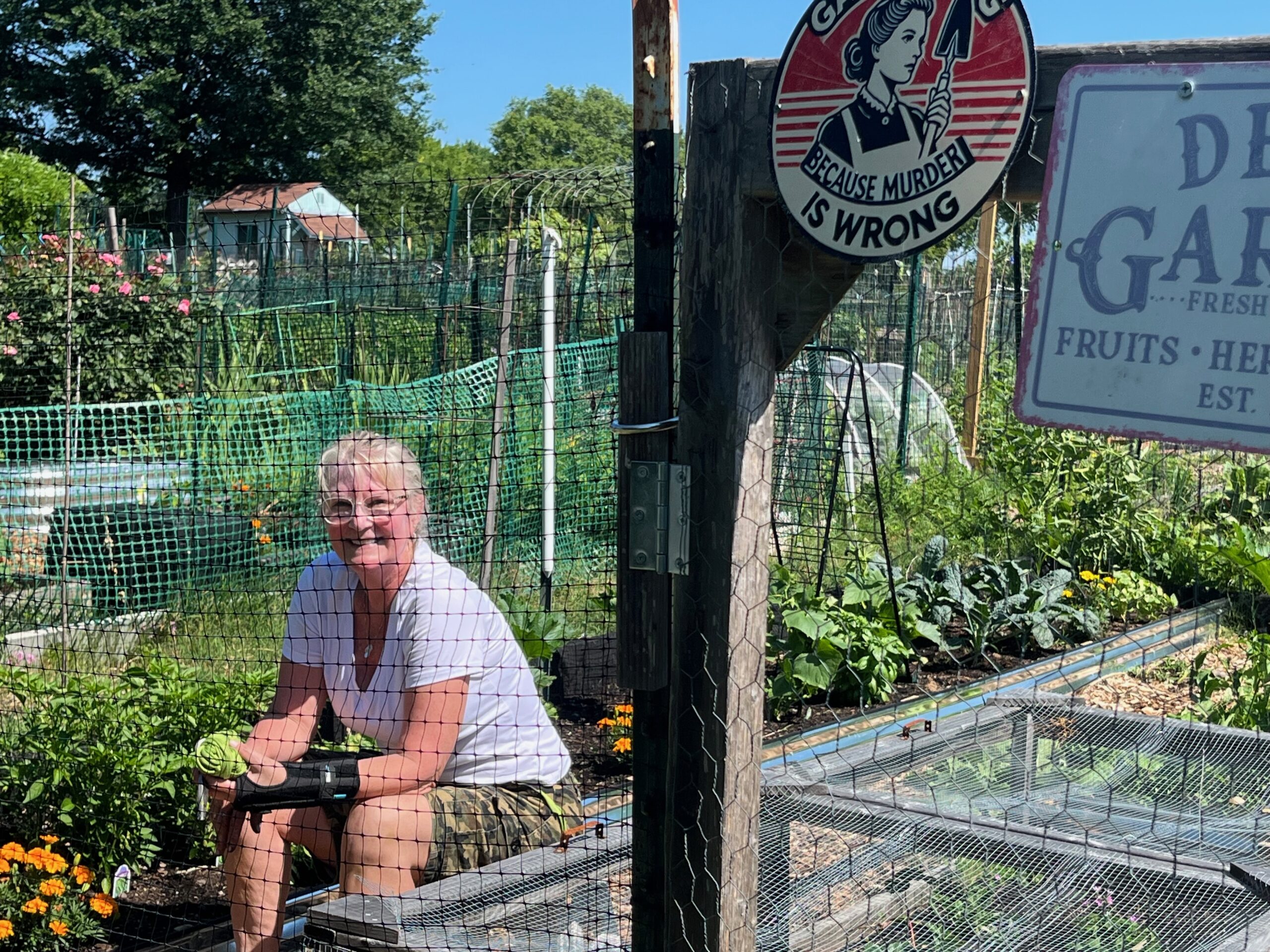 Dee Emory, who won the “best plot in the garden” during her second year of gardening a few years ago at the Chinquapin Community Garden, takes a moment to reflect on the personal rewards of being in nature as she tends her productive garden.