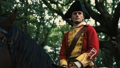 Actor William Franklyn-Miller portrays a young George Washington in British colonial military uniform while seated on horseback in a wooded setting in a scene from the feature film Young Washington.