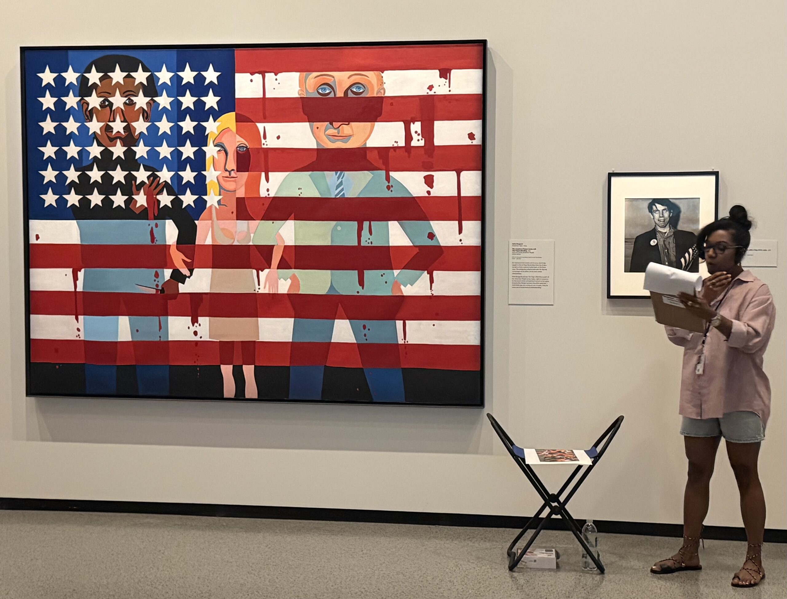 OnExhibitJuly26 04 Kanitra Fletcher, Associate Curator of African and Afro-Diasporic Art at the NGA and curator of “American Icon: The US Flag in Art,” giving a gallery talk during last month’s Art Block Party. Painting The Flag Is Bleeding by Faith Ringgold. Photo Scott MacConomy