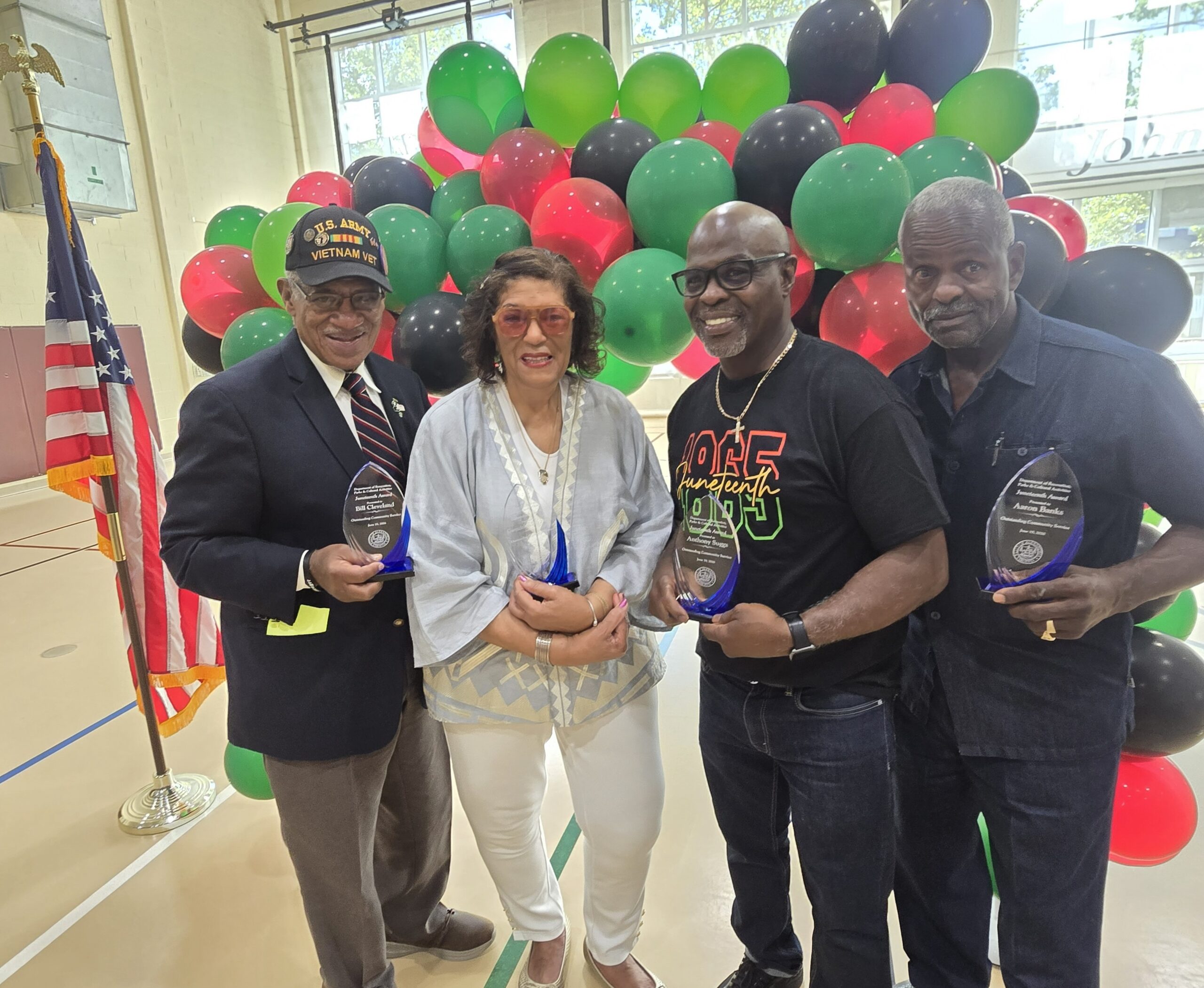 Four Awards Juneteenth Recipients of the City of Alexandria's 2026 Juneteenth Community Service Award pose following the presentation ceremony at Charles Houston Recreation Center. From left are former Alexandria Vice Mayor Bill Cleveland, Gwen Day-Fuller, Anthony Suggs, and Aaron Banks, who were honored for their decades of volunteer service and lasting contributions to the Alexandria community. Photo: Lucelle O'Flaherty