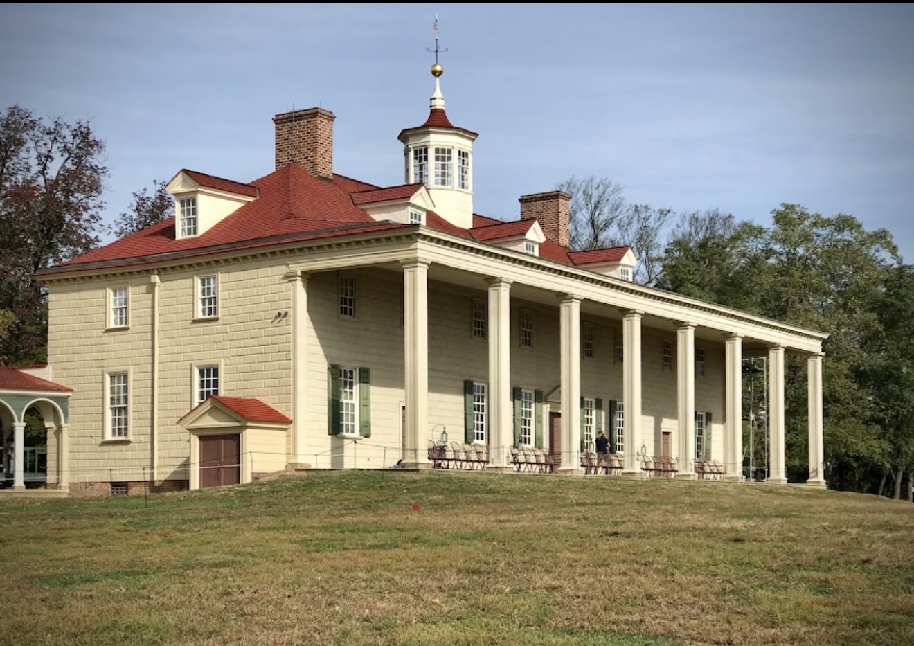 The Mount Vernon mansion with its long columned porch and red roof