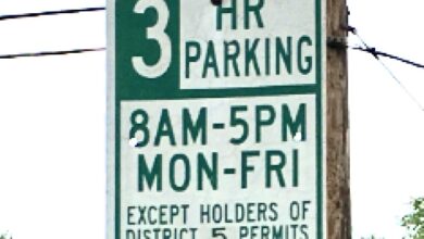 Green-and-white Alexandria parking sign reading “3 HR Parking, 8 a.m.–5 p.m., Monday–Friday, Except Holders of District 5 Permits.”