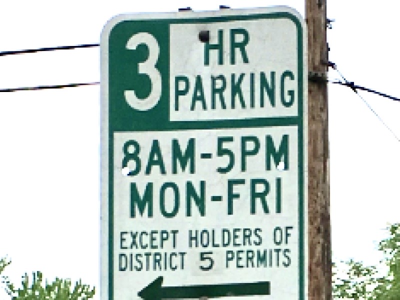 Green-and-white Alexandria parking sign reading “3 HR Parking, 8 a.m.–5 p.m., Monday–Friday, Except Holders of District 5 Permits.”