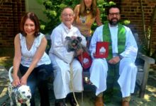 Two dogs join members of Trinity United Methodist Church for the annual Blessing of the Animals in Alexandria.