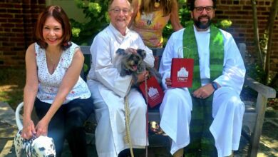 Two dogs join members of Trinity United Methodist Church for the annual Blessing of the Animals in Alexandria.