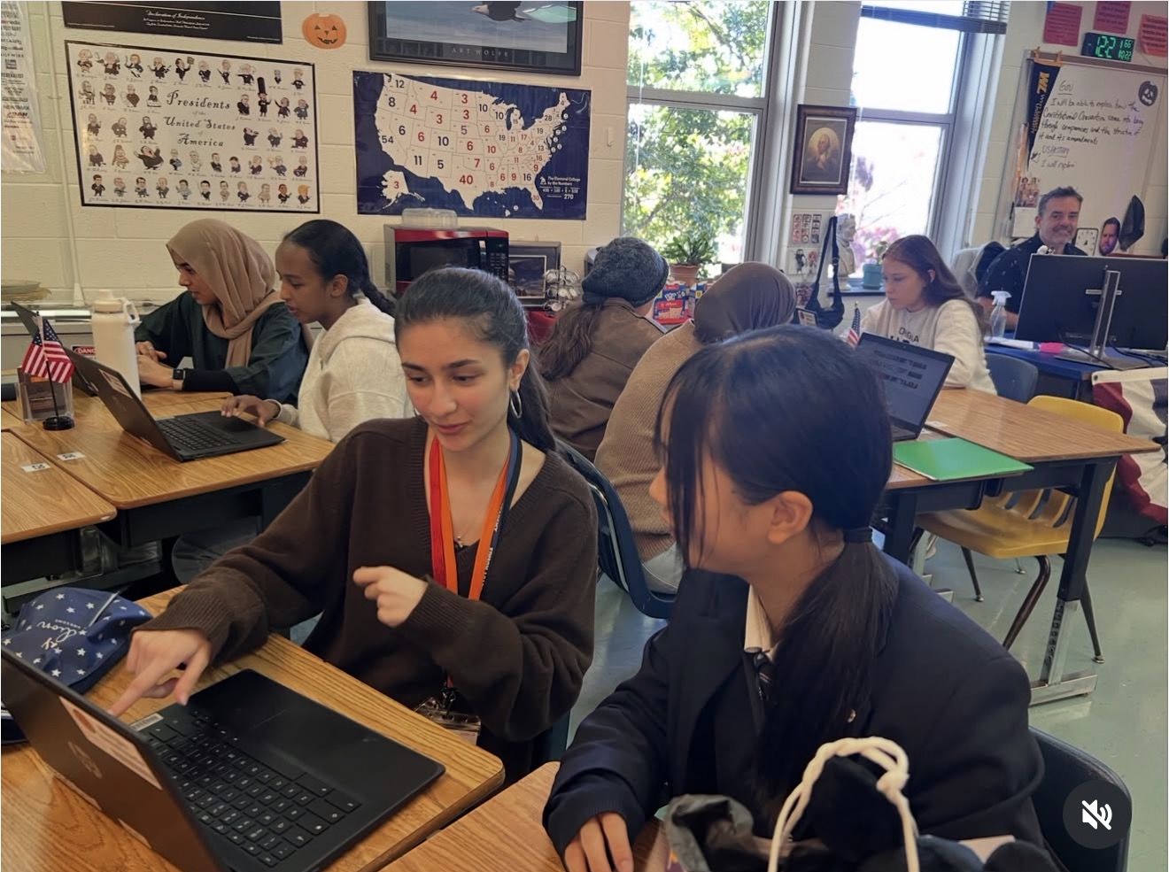Students sit together at a laptop in a Hayfield Secondary School classroom during the Suma Gakuen exchange.