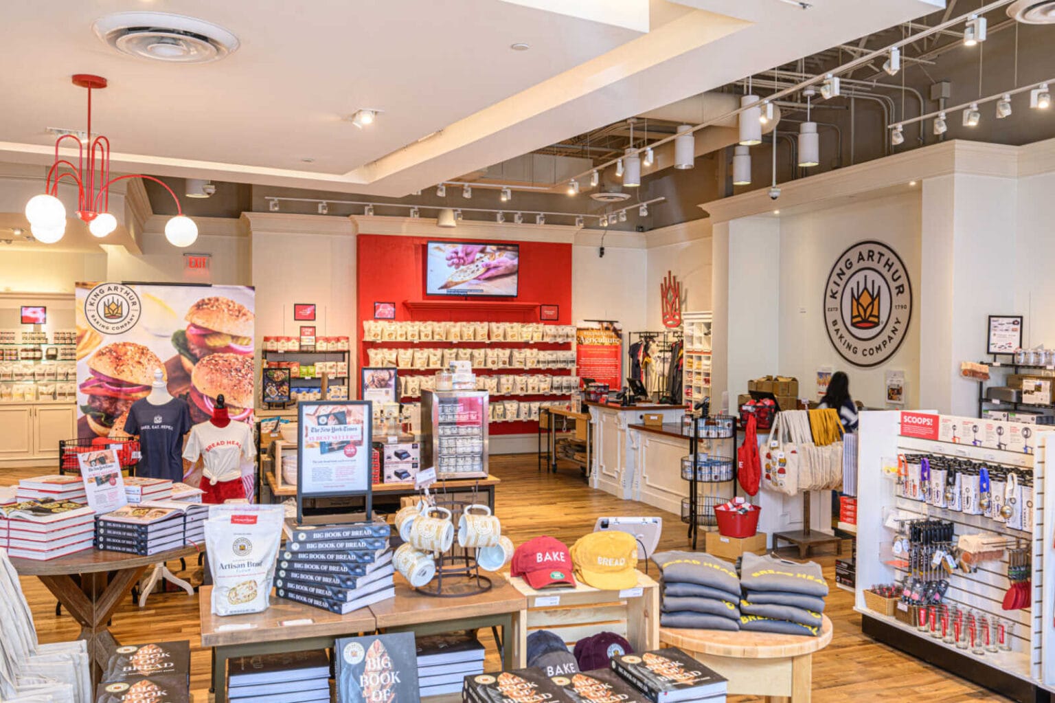 Baking ingredients, cookbooks, kitchen tools and branded gifts displayed inside a King Arthur Baking Company store.
