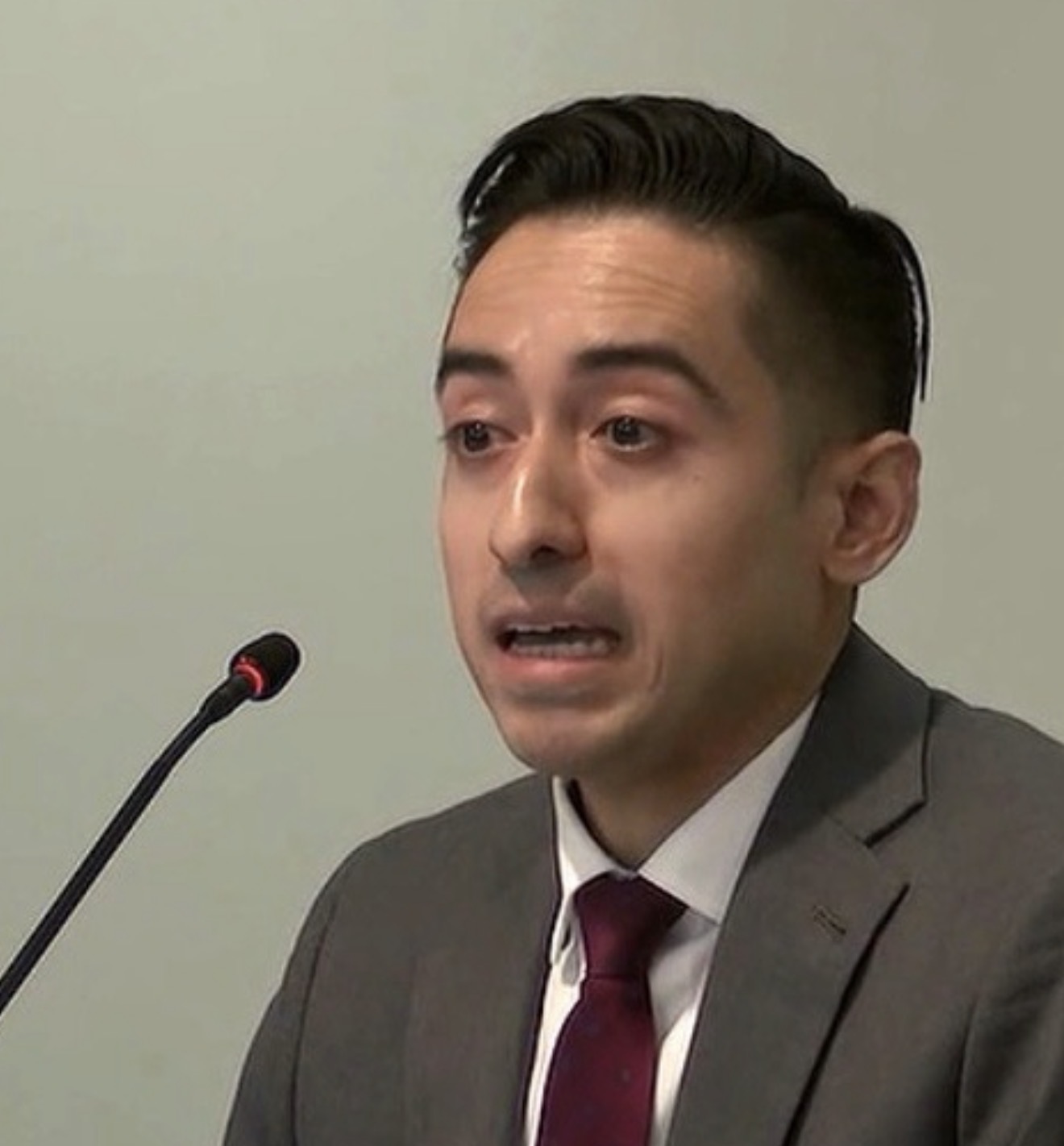 Dr. Jharrett Bryantt speaking into a microphone during a meeting in Alaska
