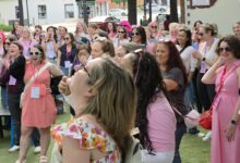 Women wearing pink gather outdoors at a previous Women’s Crawl.