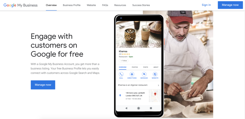 A laptop screen displays Google My Business with a smartphone showing a restaurant profile. An employee in the background is cooking. Text encourages signing up to engage with customers for free.