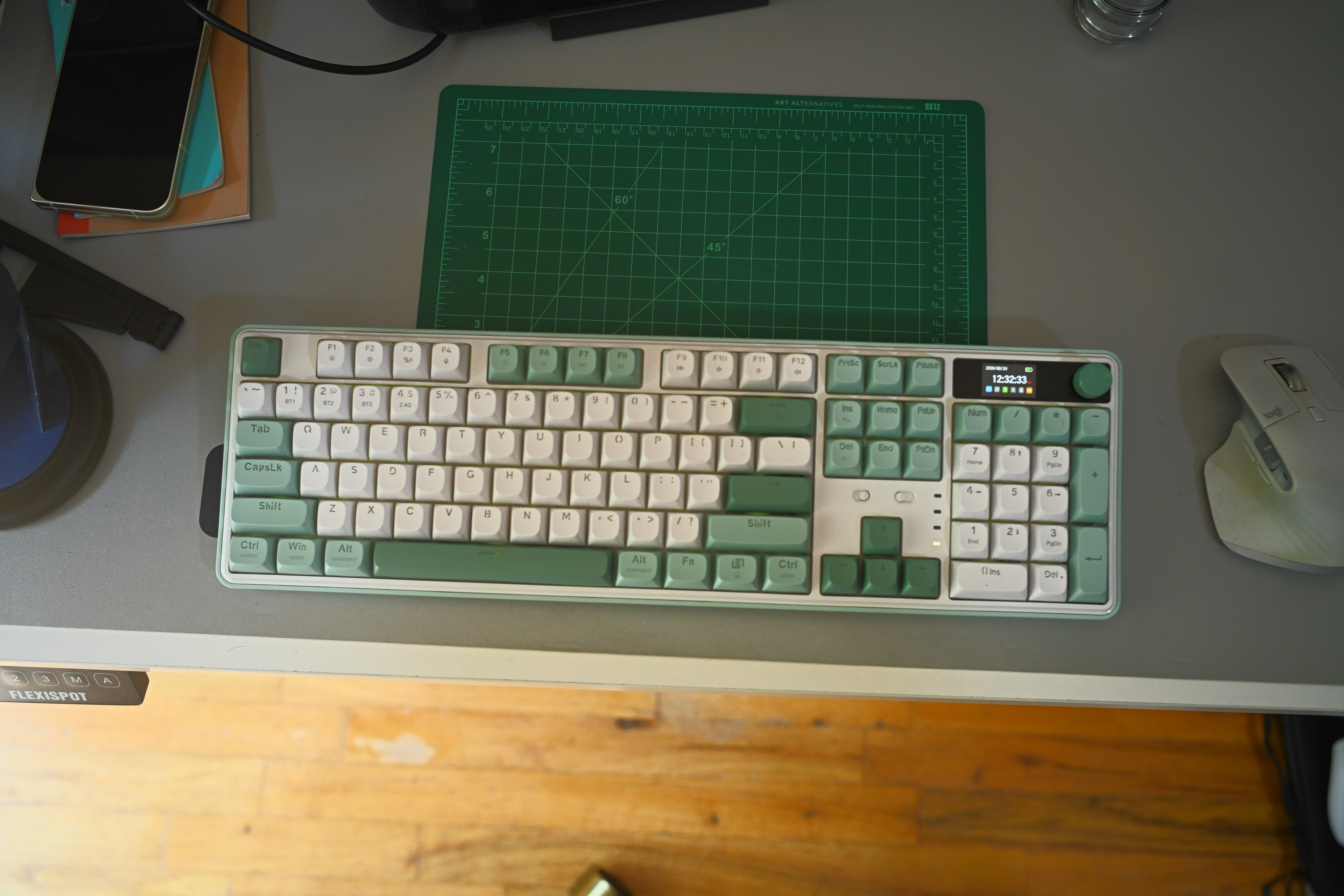 A green and white Redragon WYVERN K761 Pro sits on a desk.