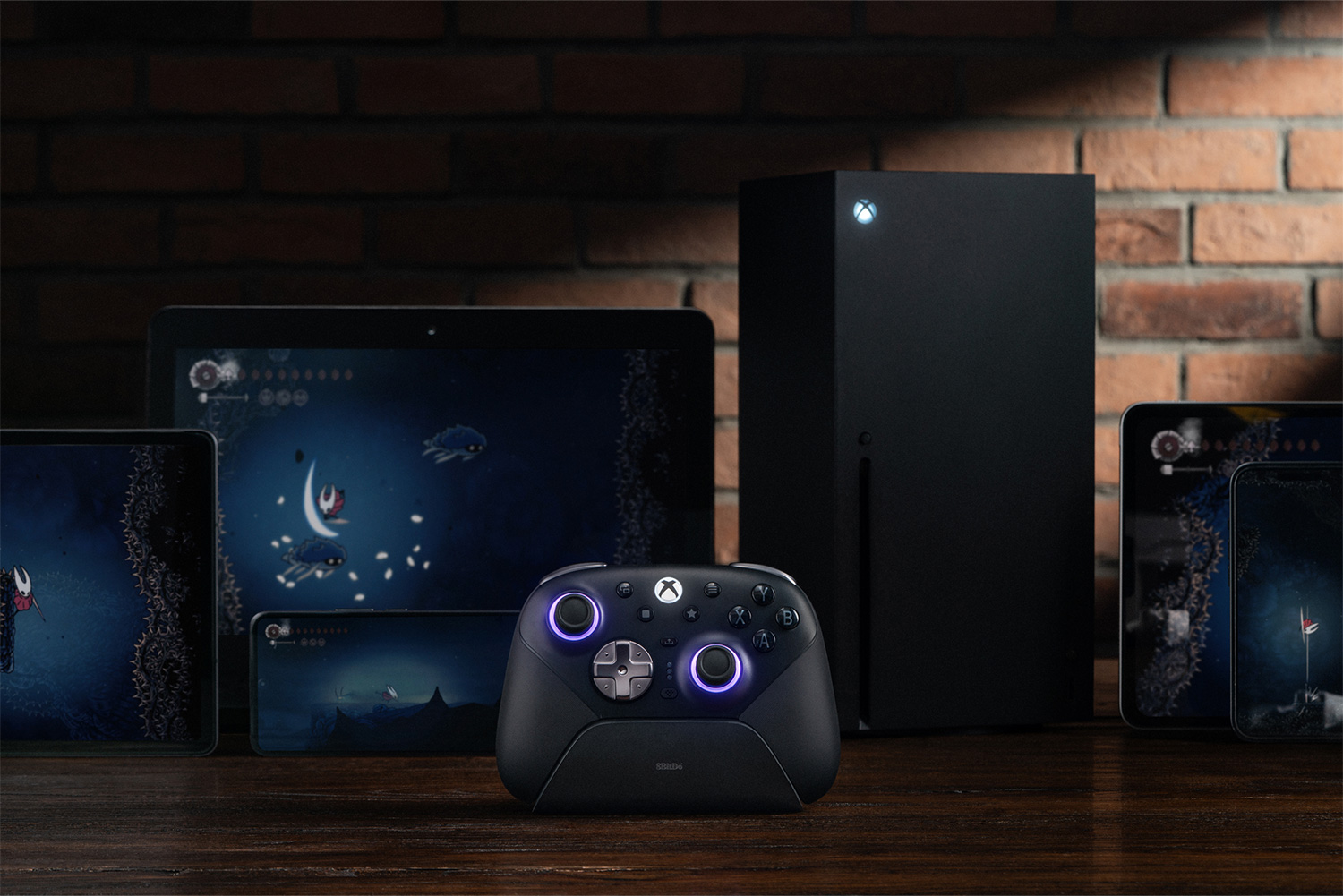 8BitDo Ultimate 3E Controller for Xbox in front of an Xbox Series X, tablets and phones
