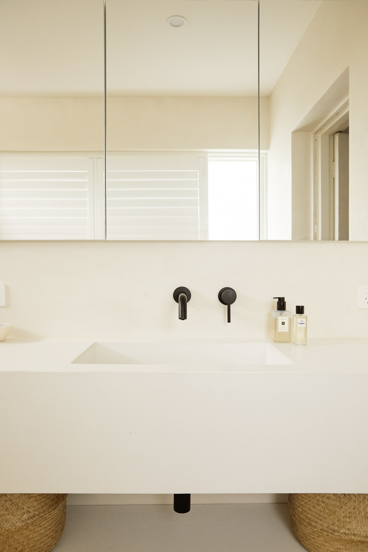 White Concrete sinks, black matte tapware, Warm minimalist bathroom in Sydney