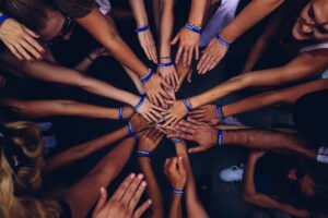 People putting together their hands, could be for good teamwork generated by good leadership style