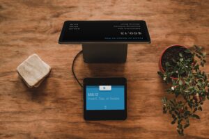 Tablet in front of computer for making electronic transactions, used by Fintech in Costa Rica