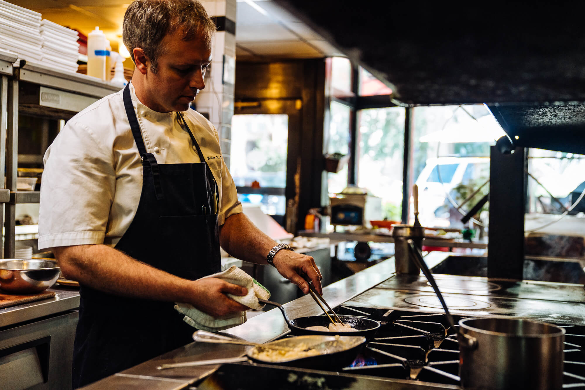 chef william dissen preparing fresh scallops at the market place asheville