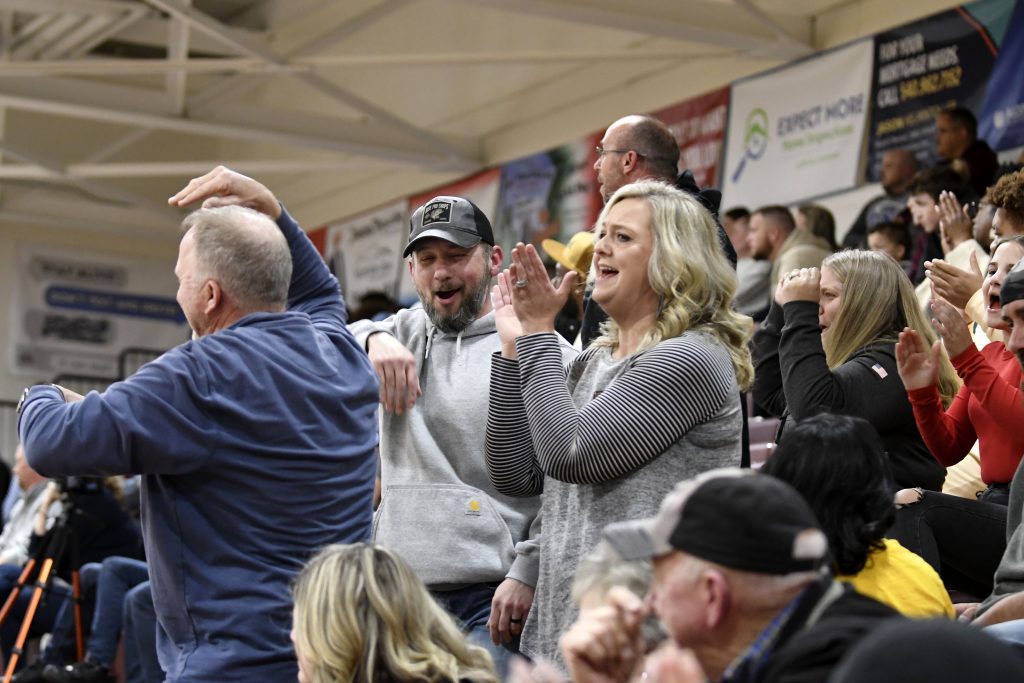 The Magna Vista cheering section celebrates after a basket by junior forward Torian Younger to put the Warriors up 62-47 with 2:53 left in the game.