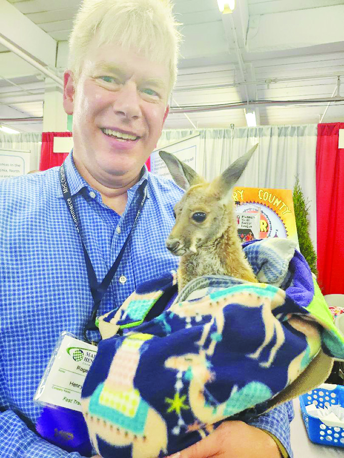 Roger Adams, director of the Henry County Parks and Recreation Department, holds Boomerang the Kangaroo to promote the Martinsville Henry County Fair.
