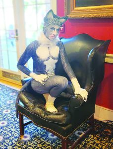 An actor from Imagine Circus dressed like a cat during cocktail hour.