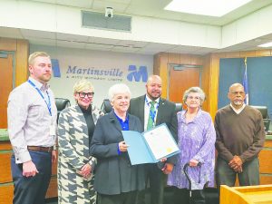 Margaret Caldwell and the members of Martinsville City Council with a resolution to recognize National Library Week.