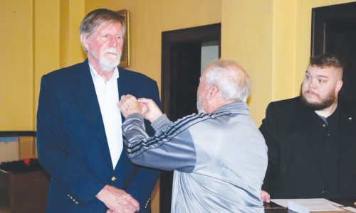 Chapter member Gene Reamey pinning new chapter inductee Gene Fain as President Jarred Marlowe looks on.