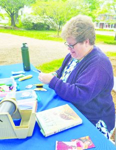 Boucher Janet makes crafts at the Gravely-Lester Art Garden for children.