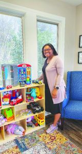 Kaneshia Coles shows off toys that are available for children to play with at the United Way’s Growth and Opportunity Center.