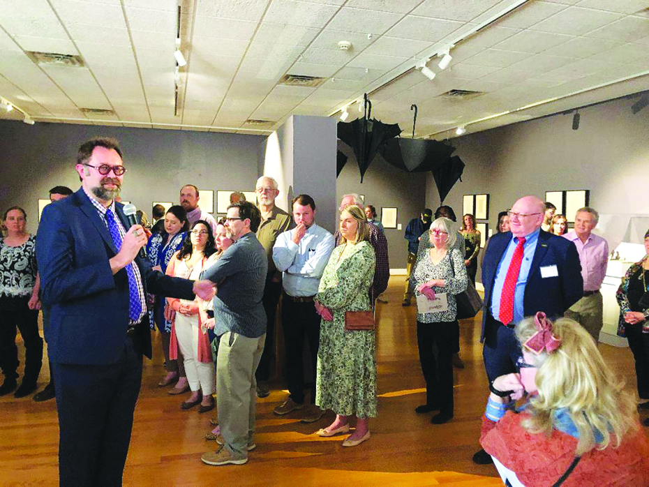 Washington & Lee University art professor Dr. Elliot King (left with microphone) describes Salvador Dali's unique work to an audience of about 150 at Piedmont Arts' exhibit opening. Dr. Michael R. Taylor, chief curator and deputy director for art and education of the Virginia Museum of Fine Arts (at right, in red tie) talked about how the VMFA researched and acquired the valuable collection.