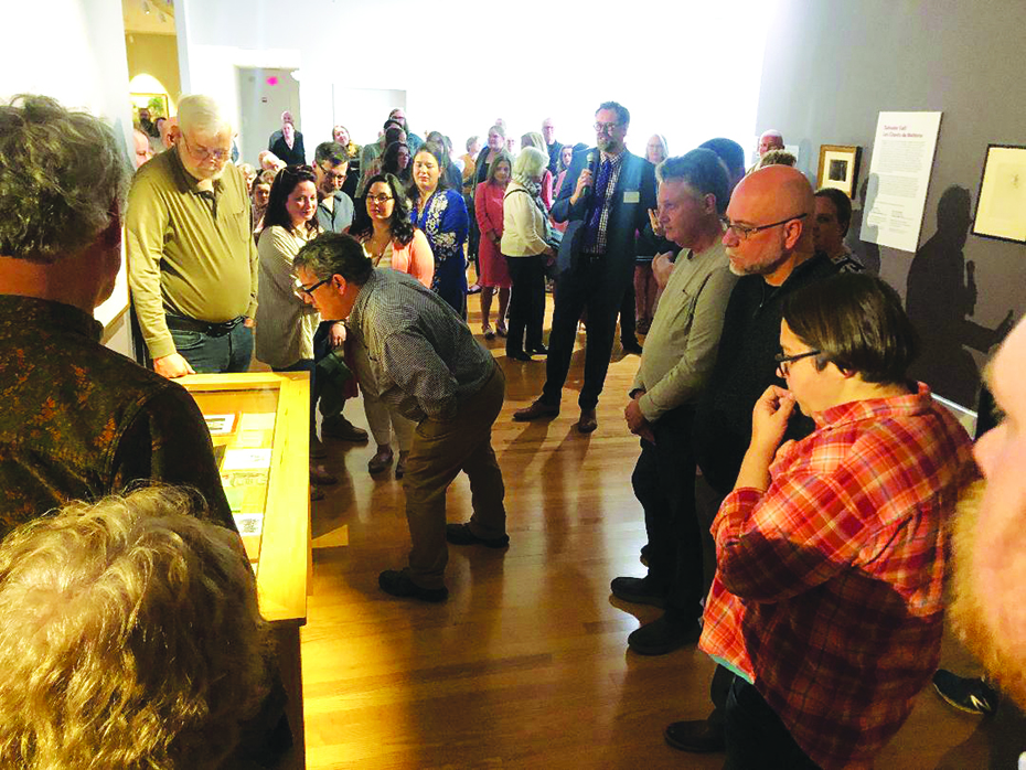 3 Dr. Elliot King walked around the gallery during his talk on Salvador Dali's art, and the audience followed, taking close looks at the etchings.