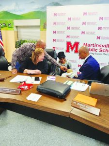 Martinsville City Schools Superintendent Dr. Zebedee Talley, Jr. and Yvonne Givens meet an armadillo from Infinity Acres Ranch.