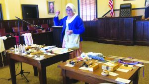 Dressed in Colonial garb, Gail Vogler describes how children played in the early days of settlement of America. (Photo by Holly Kozelsky)