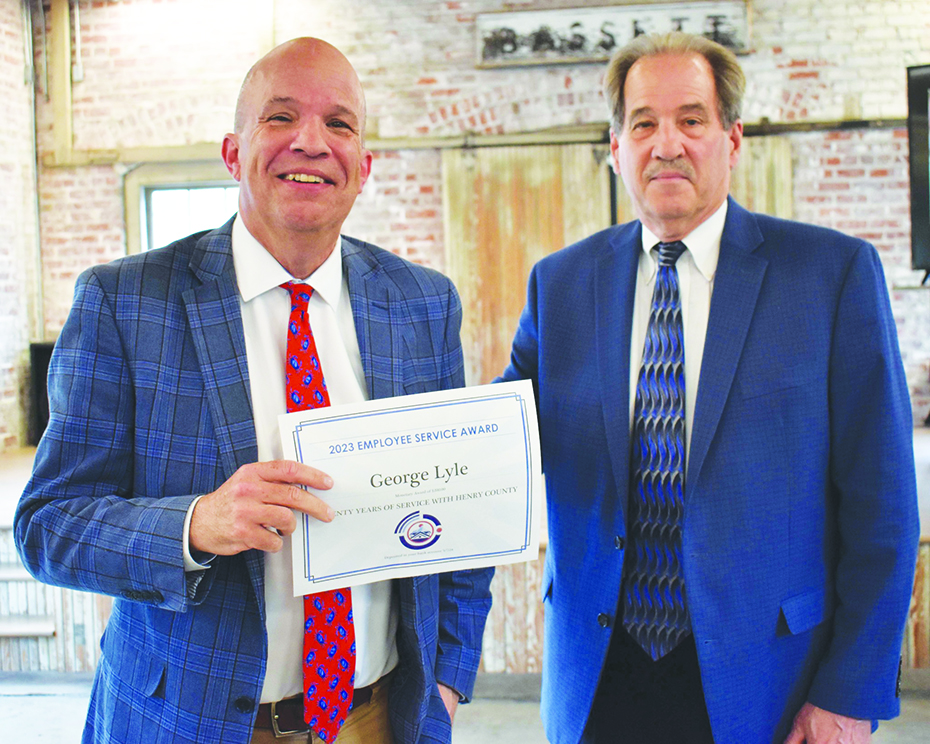 County Attorney George Lyle was recognized for 20 years of service. He is pictured with Jim Adams, chairman of the Henry County Board of Supervisors.