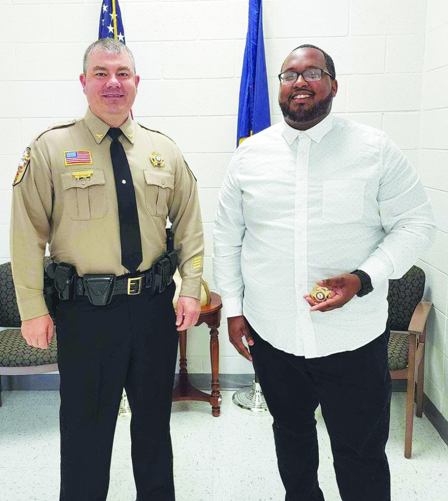 Golden works in corrections at the Adult Detention Center. He is pictured with Sheriff Wayne Davis (left).