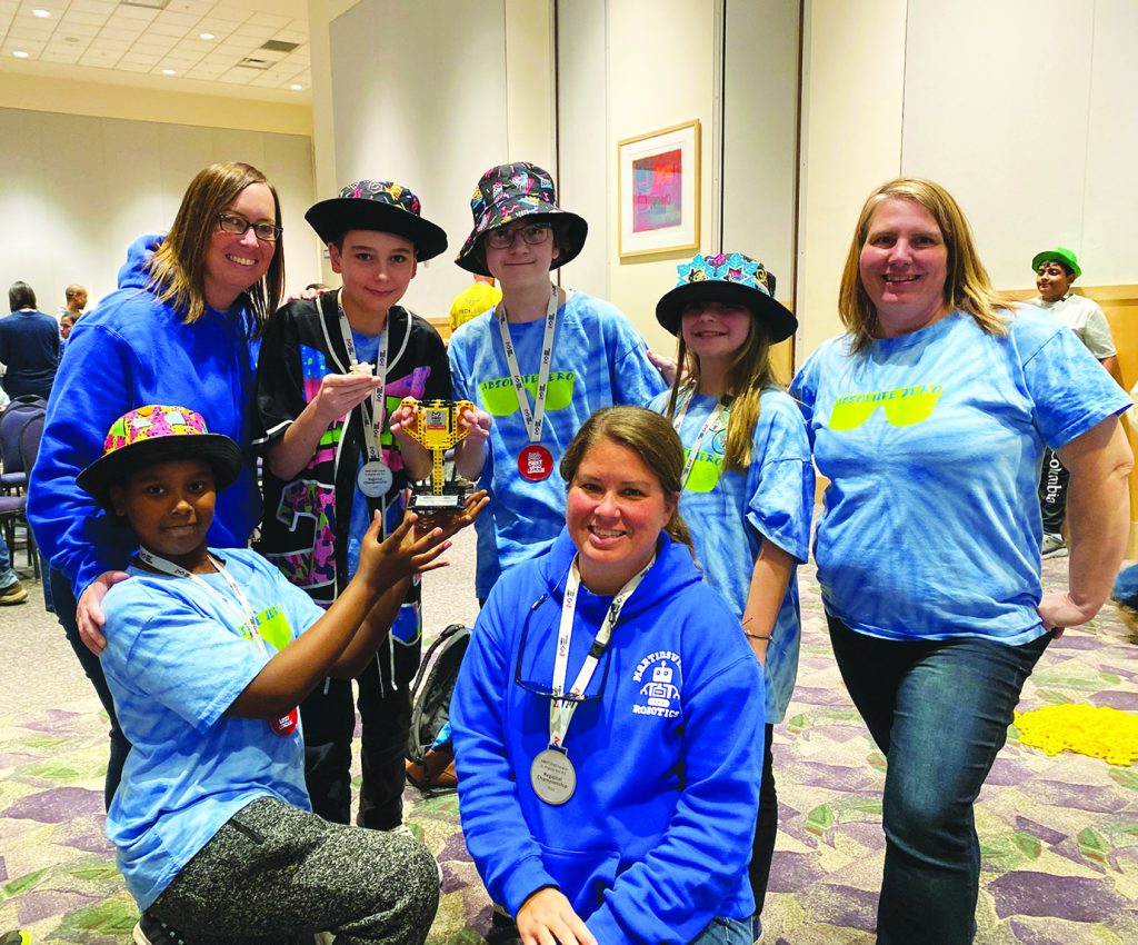 Elizabeth “Liz” Lynch (right, back row) also is a coach for Odyssey of the Mind, First Lego League Lego Robotics, KidWind, and the King’s Dominion Roller Coaster Engineering Challenge.