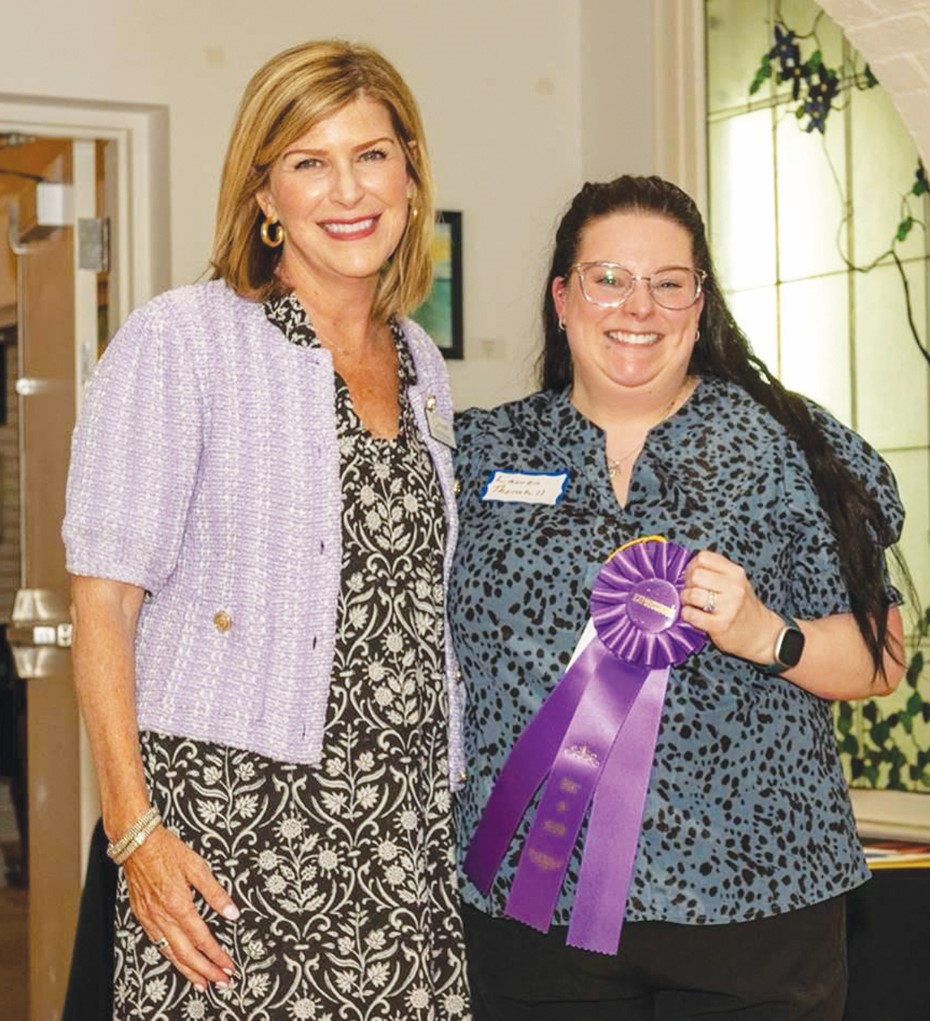 Best in Show winner Lauren Thornhill is all smiles as she poses with Executive Director Heidi Pinkston. Thornhill’s winning mixed media piece, “A Crow’s Gift” is on display in the galleries until July 26.