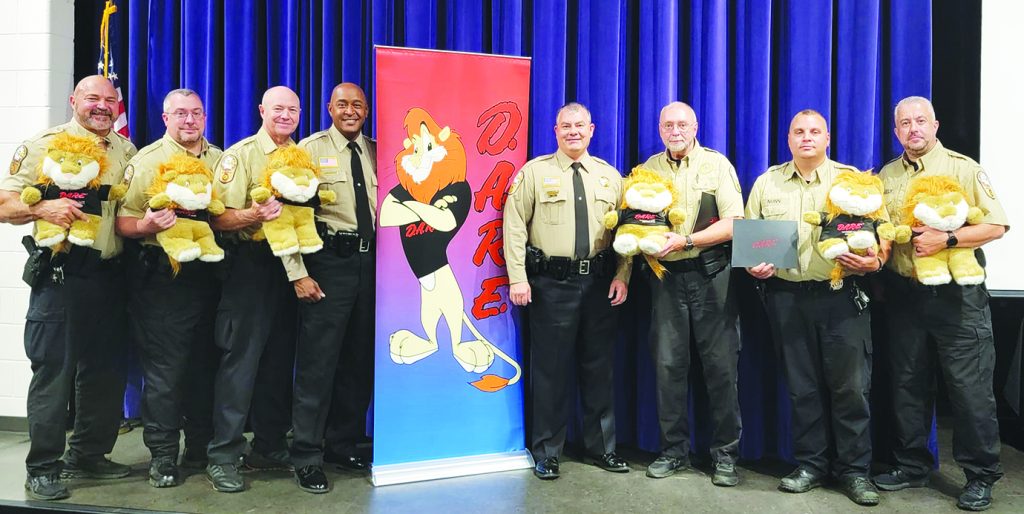 Henry County Sheriff Wayne Davis (center right) and Capt. Sandy Hine (center left) are shown with the six local deputies who completed D.A.R.E. training.