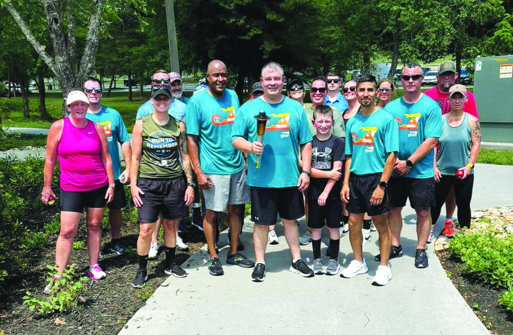 Henry County Sheriff Wayne Davis (with the torch) was among the county and city officers participating in the Special Olympics Torch Run.