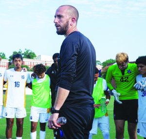 Coach Brennan Murphy addresses players following a preseason exhibition game.