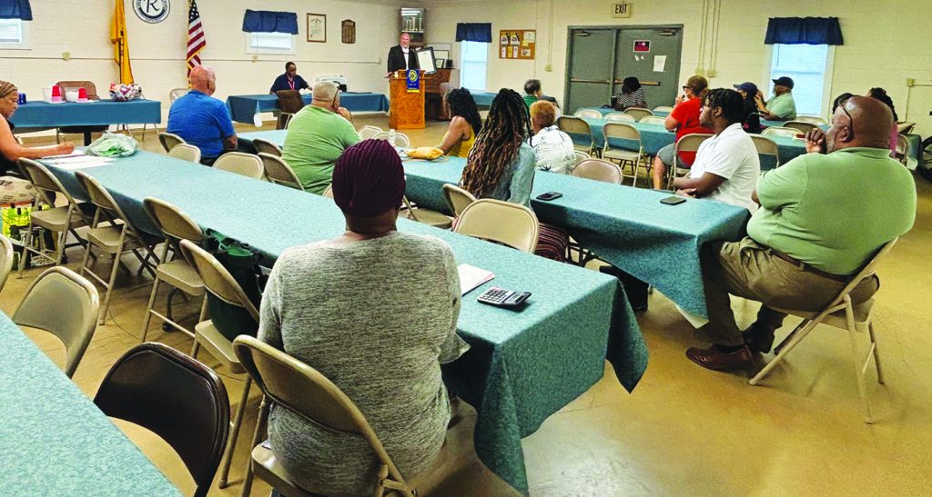 Members of the Carver Road Ruritan Club listen as Del. Eric Phillips reads a resolution approved by the state to honor the club’s commitment and dedication to the community it serves.